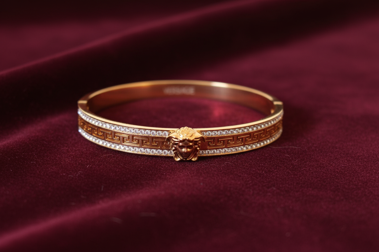 Gold Greek key bracelet on burgundy velvet – side view